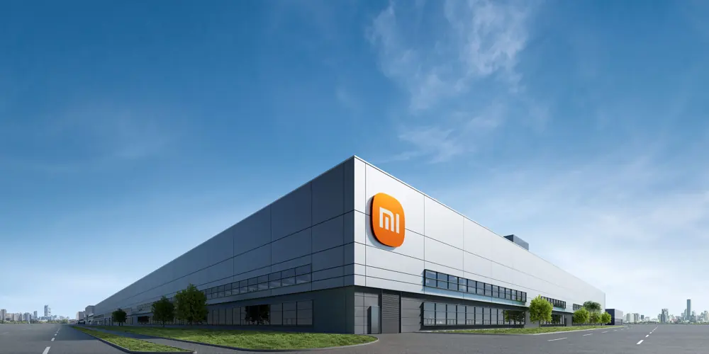 Xiaomi's EV factory building exterior with the Mi logo on the facade